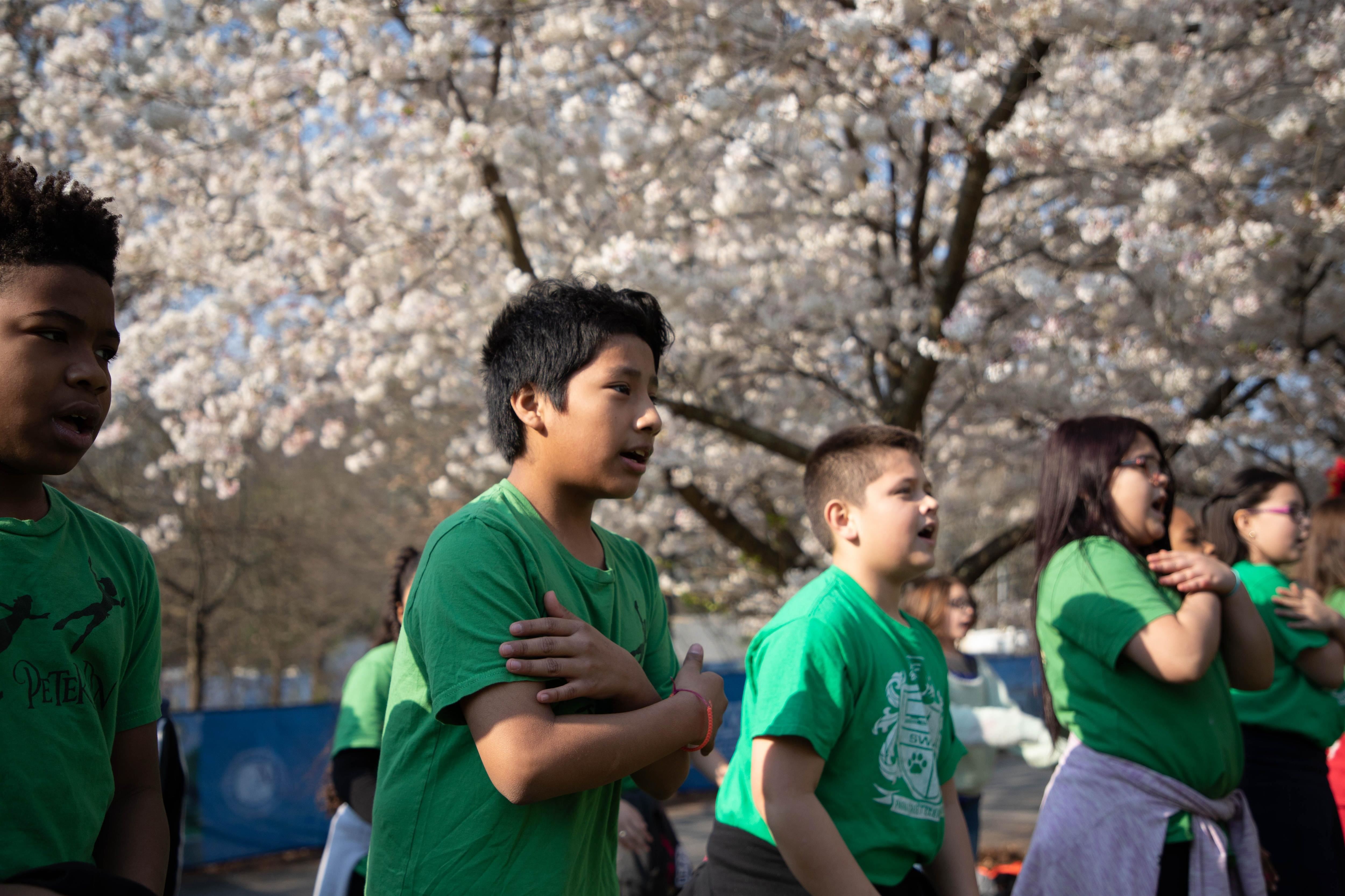 Children in a line playing an outdoor game